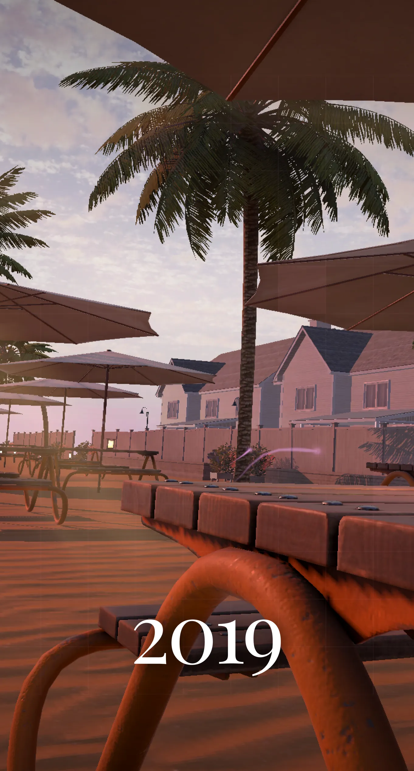 A 2019 memory: a beach club at sunset, palms over the picnic tables