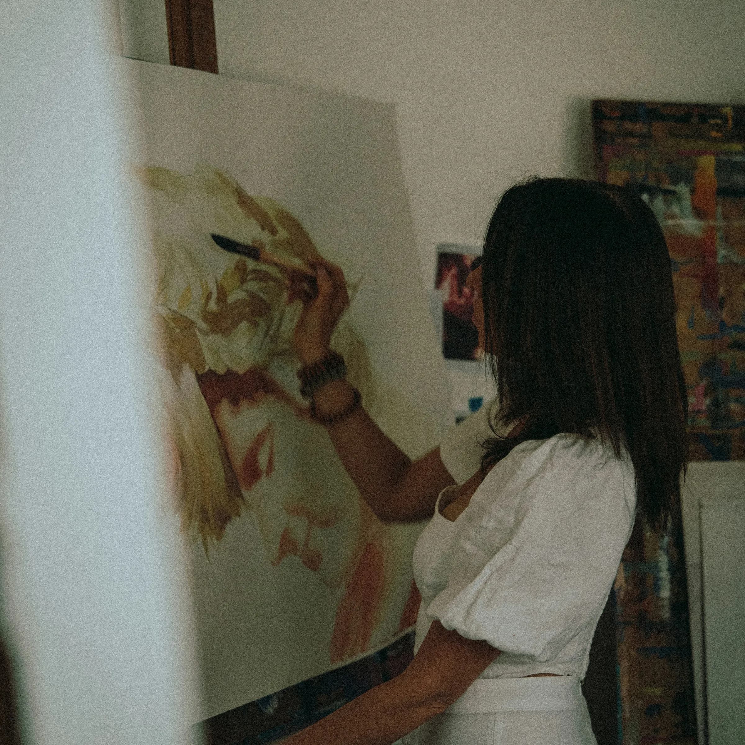 A painter working on a portrait in her studio