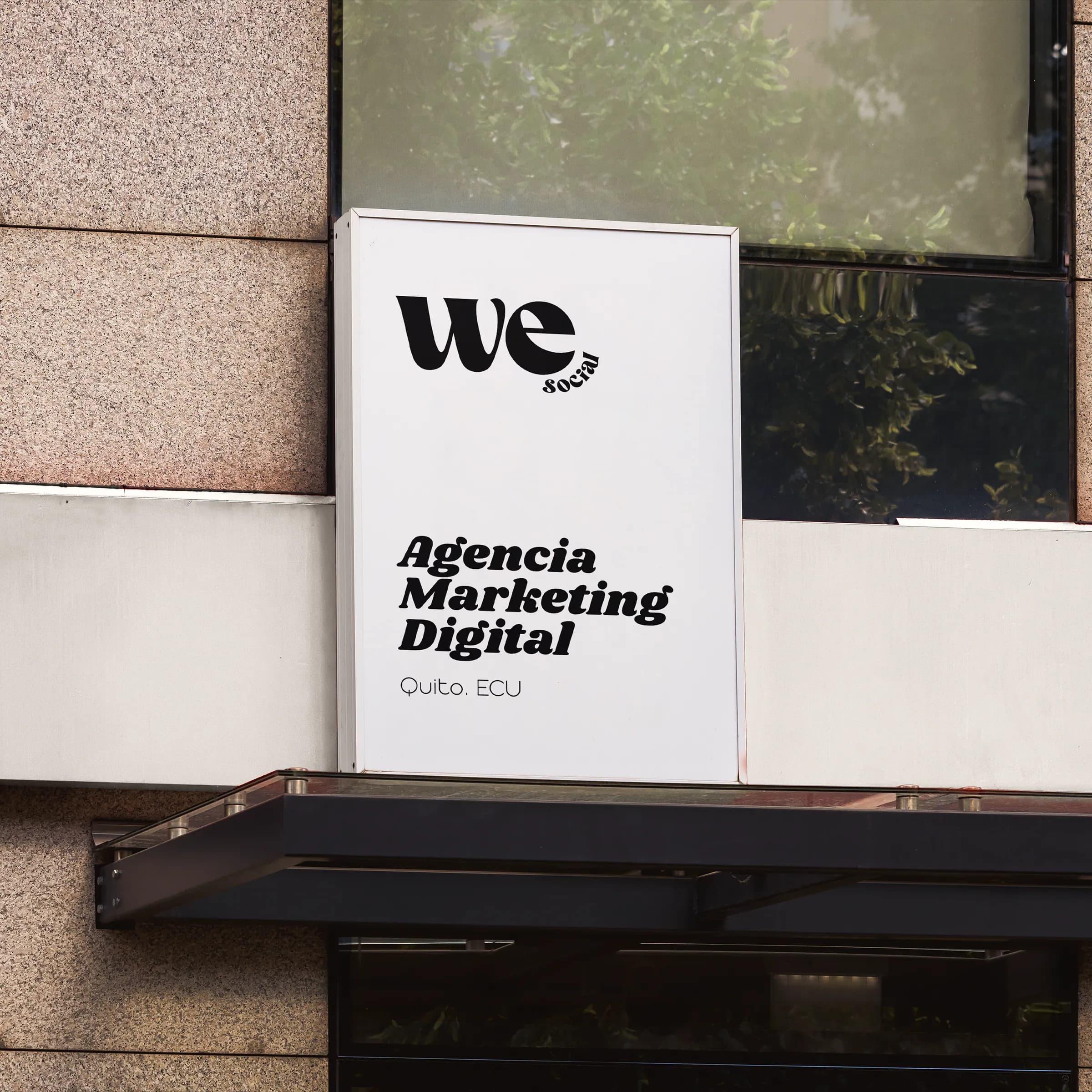 The We Social wordmark on an exterior sign reading Agencia Marketing Digital, Quito, Ecuador