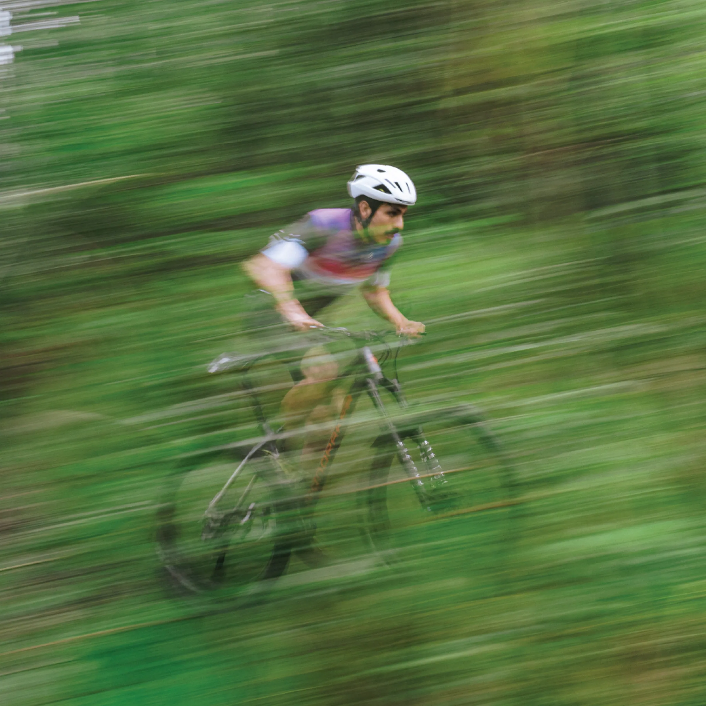 A cyclist captured with motion blur, part of We Social's audiovisual work